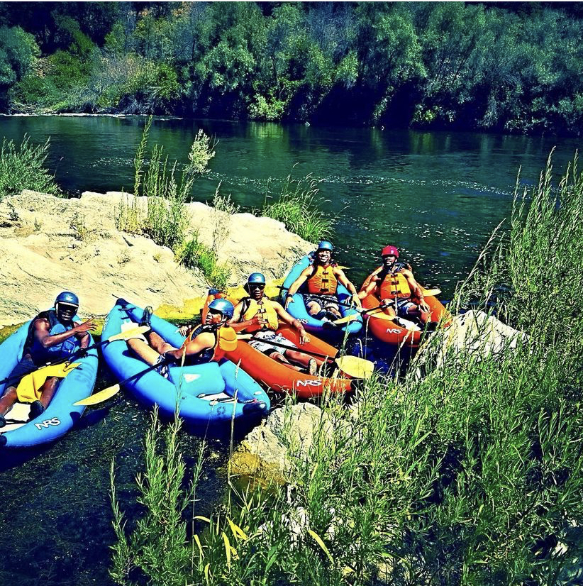 Rafting group resting on riverbank